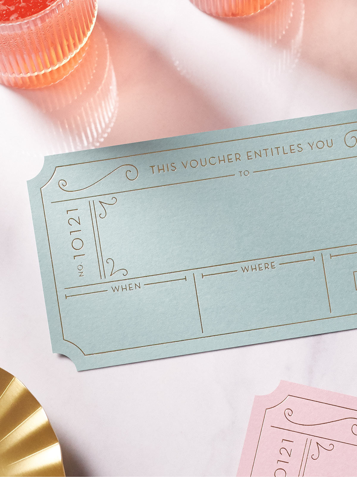 Avocado green Golden Ticket voucher with Hot Foiled in gold , pink golden ticket around it on a white background