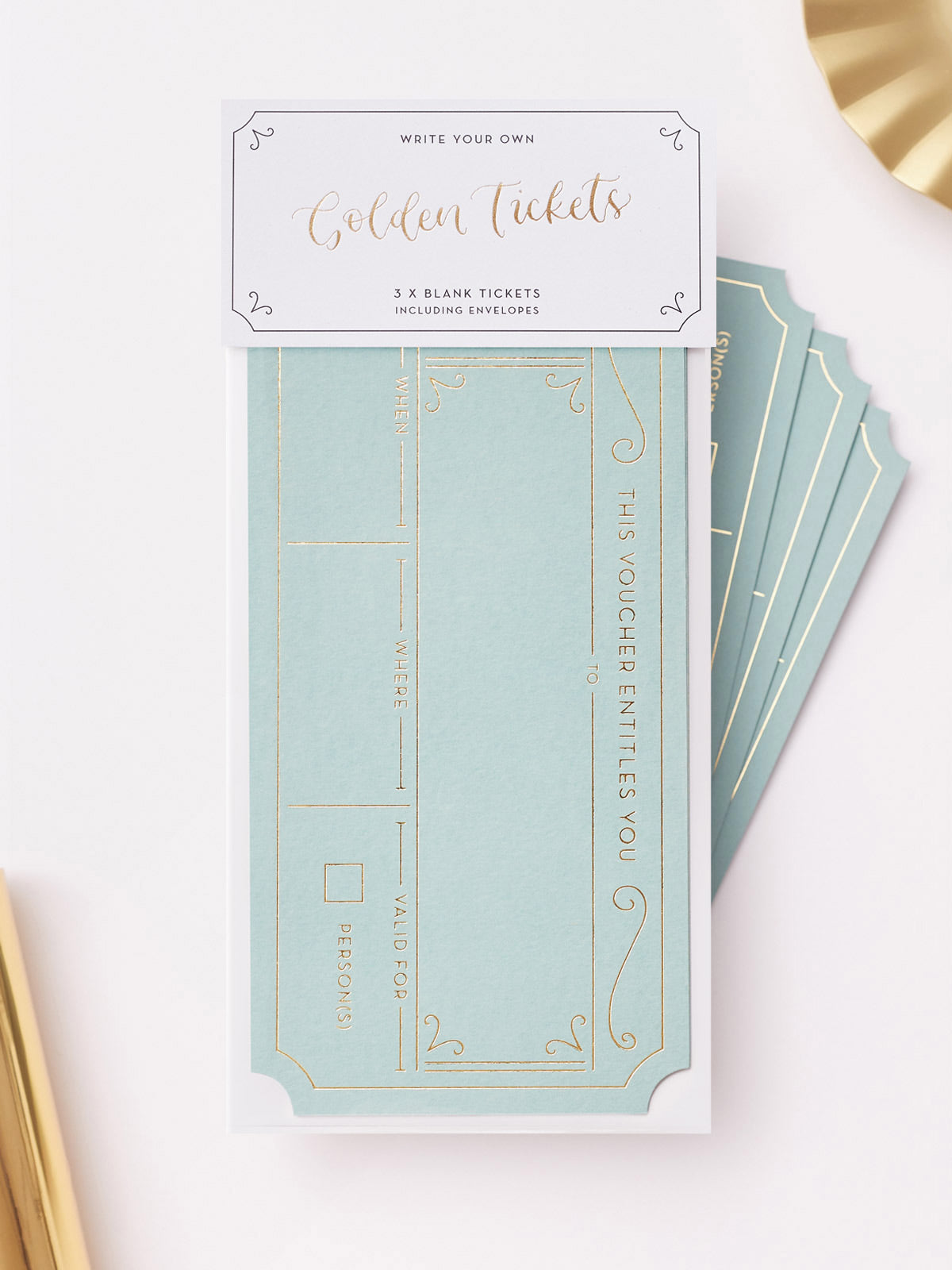 A set of 3 avocado green hot foiled golden tickets. With matching grey envelopes, displayed on a clean white background with decorative gold paper props.