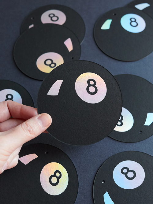Black 8 Ball Lucky Token Hot Foiled by hand with holo foil held in a hand